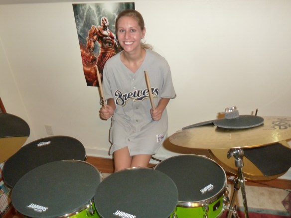 As you can see, I'm super excited about my new drum set! I'm sporting my XL Brewers jersey here. It looks like a dress, but I am wearing shorts. :P